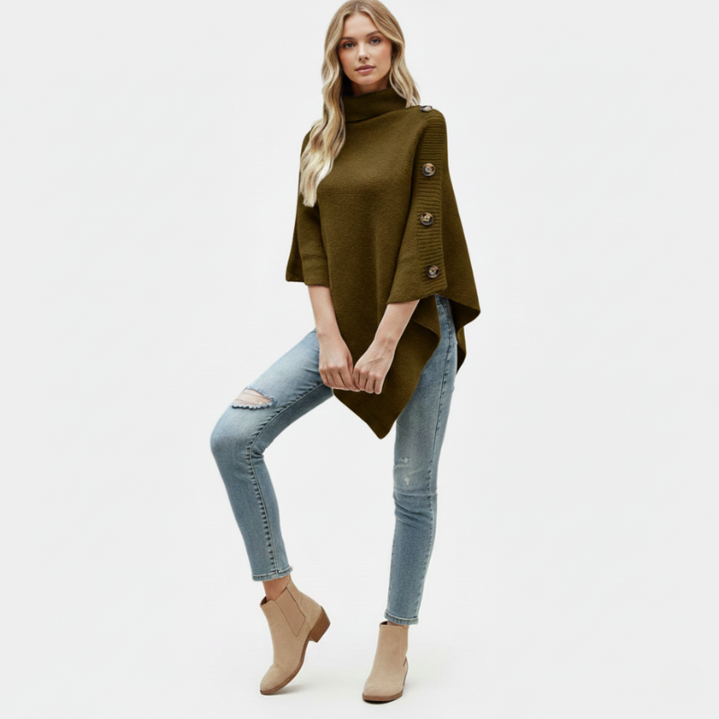 Woman wearing a khaki poncho with buttons, light blue jeans, and beige ankle boots on a white background