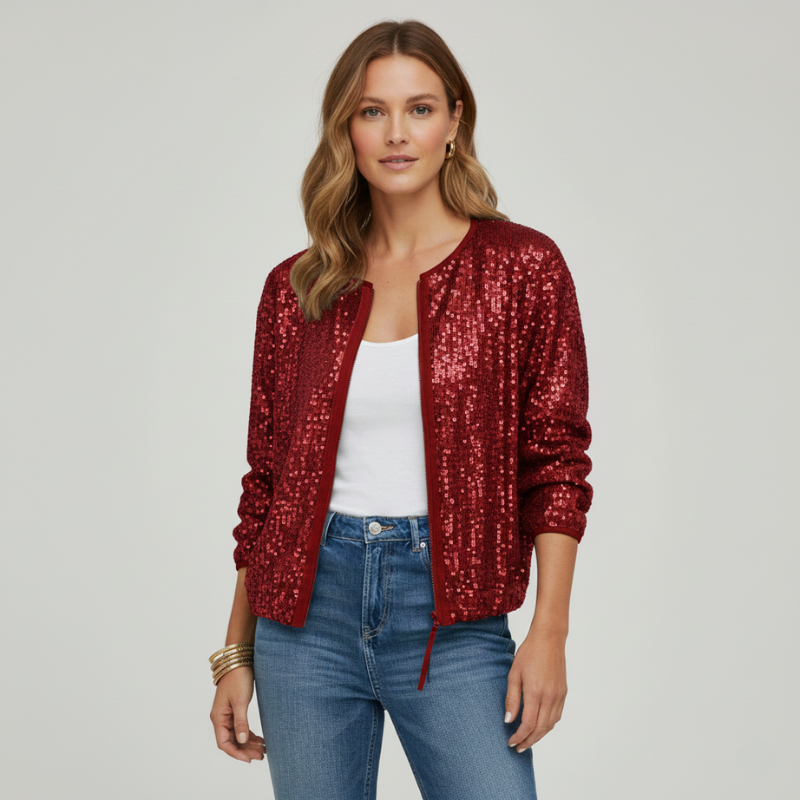 Woman wearing a red sequin jacket, white top, and blue jeans on a plain background