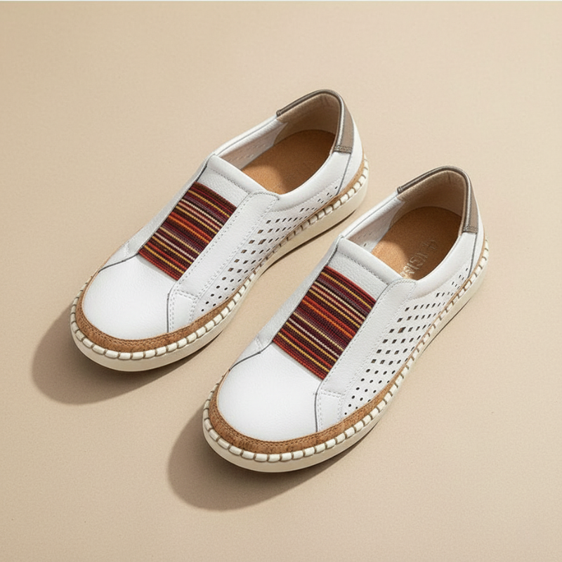 White slip-on shoes with brown striped accents on a beige background
