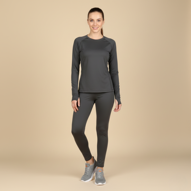 Woman wearing a gray long-sleeve top and leggings on a beige background