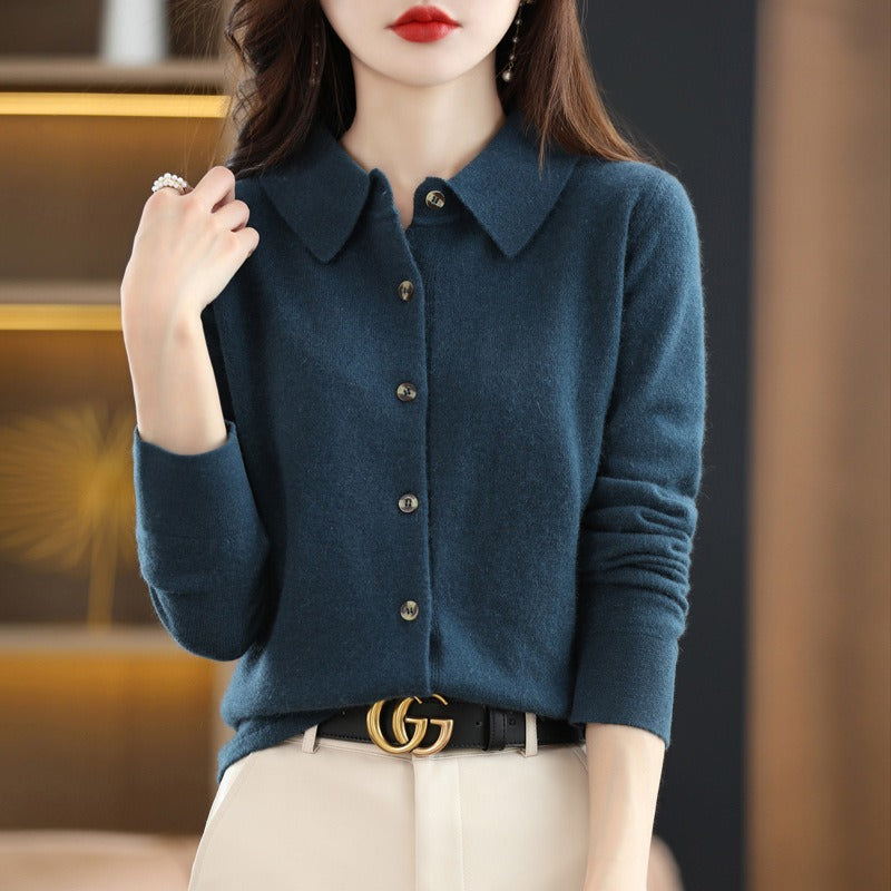 Woman wearing a blue cardigan with a blurred background