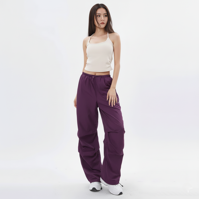 Female model posing in utility-style cargo pants with a relaxed wide-leg fit.