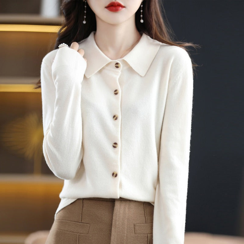 White blouse with buttons worn by a person, blurred background