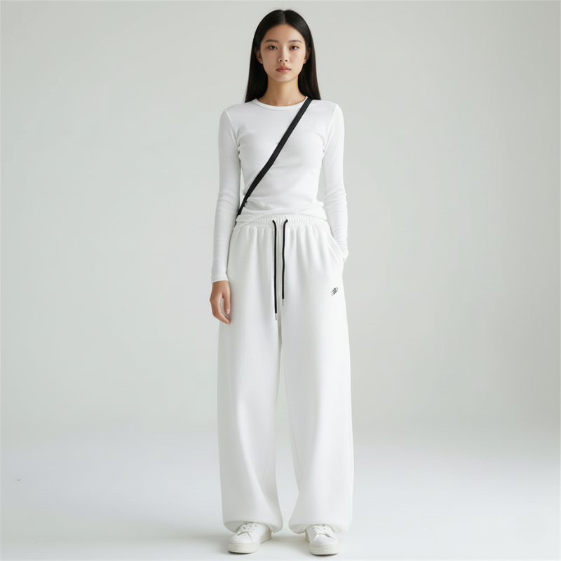 Female model wearing a white knit two-piece outfit with a relaxed fit and wide-leg pants.