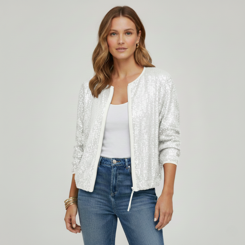 Woman wearing a white sequin jacket over a white top and blue jeans on a gray background