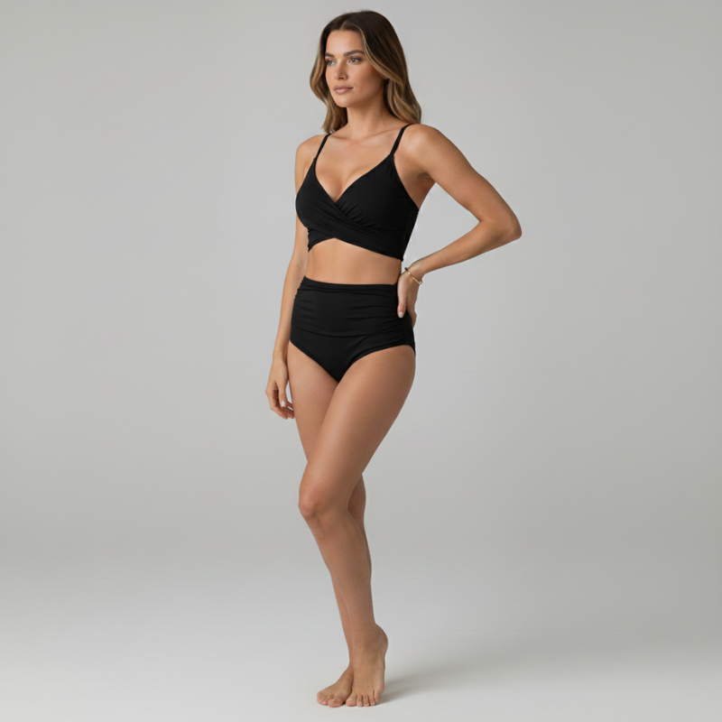 Woman wearing a black bikini on a gray background